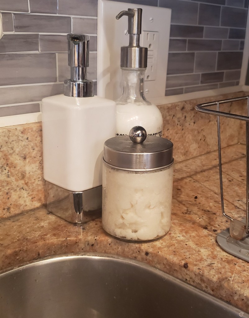 In the Kitchen: I keep a jar next to the sink so my hands can have some extra love during the dry, increased hand-washing season. I use a jar that has an easy release lid. The scrub is great for getting hands extra clean and the coconut oil and vitamin e soothe and restore. Additionally, since the scrub is made from 100% edible ingredients, the scrub is safe to use in the kitchen and near dishes.